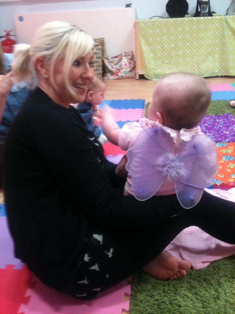 Woman smiling at baby